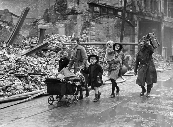 Mr C. E. Mill and family passing through the devastated streets of residential Plymouth