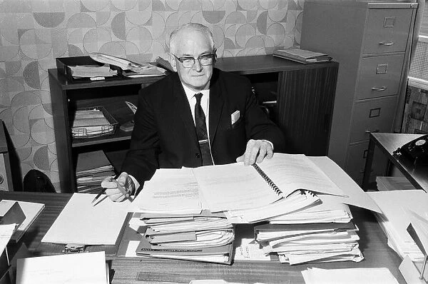 Mr Eric Jackson, deputy town clerk of Irlam UDC, amongst the files of his campaign