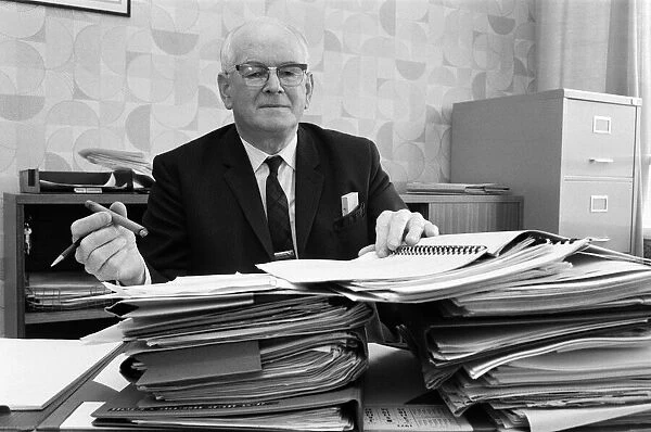Mr Eric Jackson, deputy town clerk of Irlam UDC, amongst the files of his campaign
