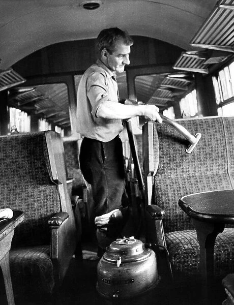 Mr. Frank Baley vacuums seats while cleaning a carriage ready for another journey on 10th