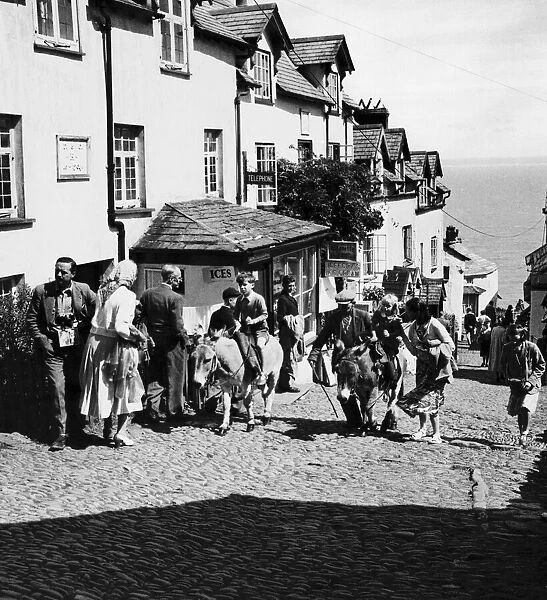 Mr Gulliver (left) takes a party of elderly people from the harbour of Clovelly, Devon