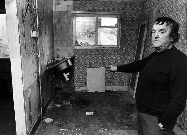Mr John McGuire points to flood damage to his kitchen. Tower Hill Estate, Kirkby