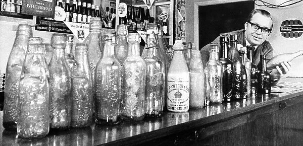 Mr. John Ruddick the Plough Inn landlord at Haswell, and some of the old bottles