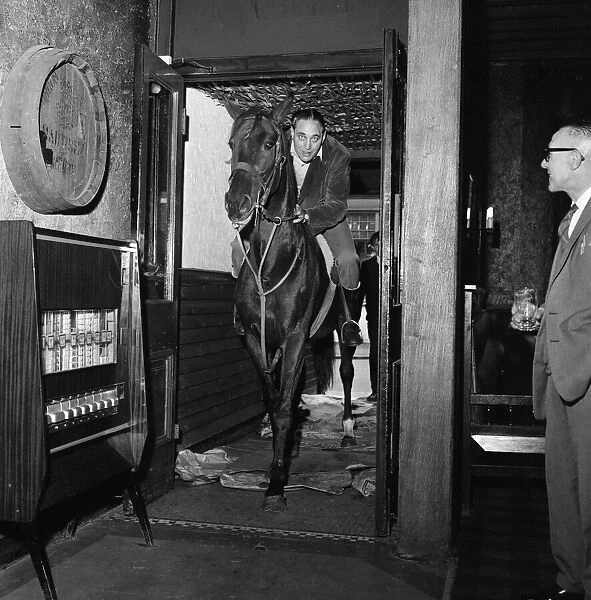 Mr Leslie Johnson rides his horse 'Lady'into the bar of the Fox and Goose