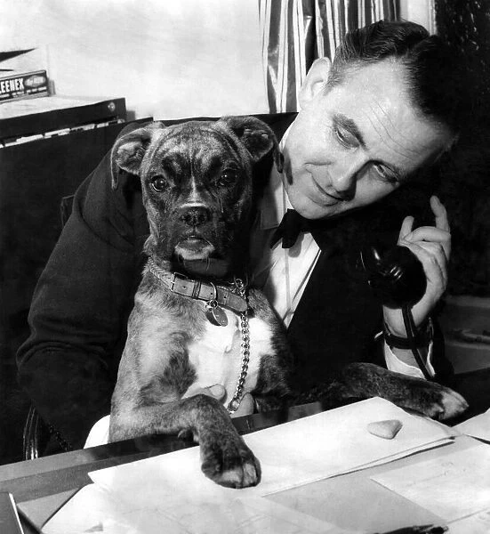 Mr. Marshall speaks on the telephone. Tina looks on. January 1959 P007296