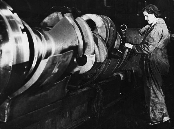 Mrs. Annie Kelly, typical of these women of steel. She is working hard boring a shaft of