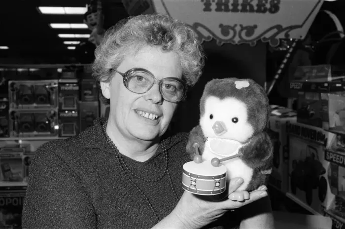 Framed Print : Mrs Beryl Bennington, Rackhams toy department manager, with a drumming penguin toy Framed Print : Mrs Beryl Bennington, Rackhams toy department manager, with a drumming penguin toy