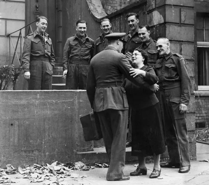 Framed Print : Mrs Cecilia Tarrant of 7 Camberwell Grove, London, greets her returning son Charlie with Framed Print : Mrs Cecilia Tarrant of 7 Camberwell Grove, London, greets her returning son Charlie with