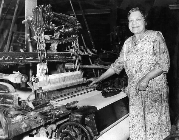 Mrs. Clara Abbott (70), at work on her loom in the cotton mills. April 1959 P005449
