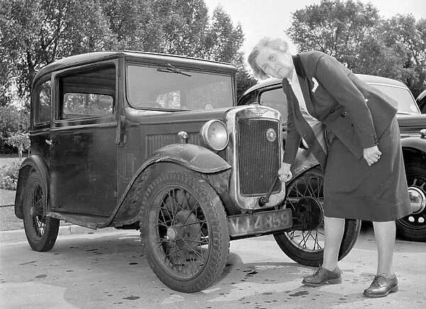Mrs Goul tries to start her car with the starting handle Circa 1957