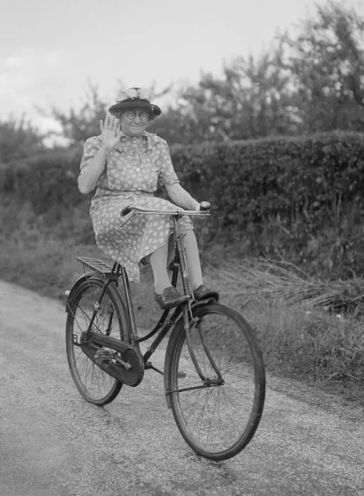 Framed Print : Mrs Hilda Baker seen here coasting downhill on her bicycle with her feet up on the front Framed Print : Mrs Hilda Baker seen here coasting downhill on her bicycle with her feet up on the front