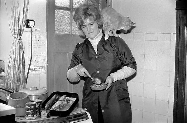 Mrs. Marlene Harris seen here preparing lunch for, cats Suki