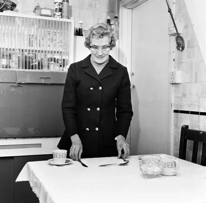 Framed Print : Mrs Mary Fullaway sets a place at her table in her Corporation house in Aycliffe Avenue