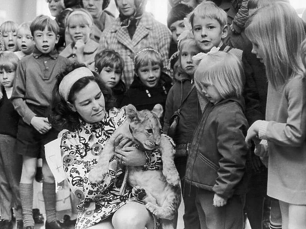 Mrs Maureen Waite, of Coventry Zoo holds Richard the lion cub after he had opened a
