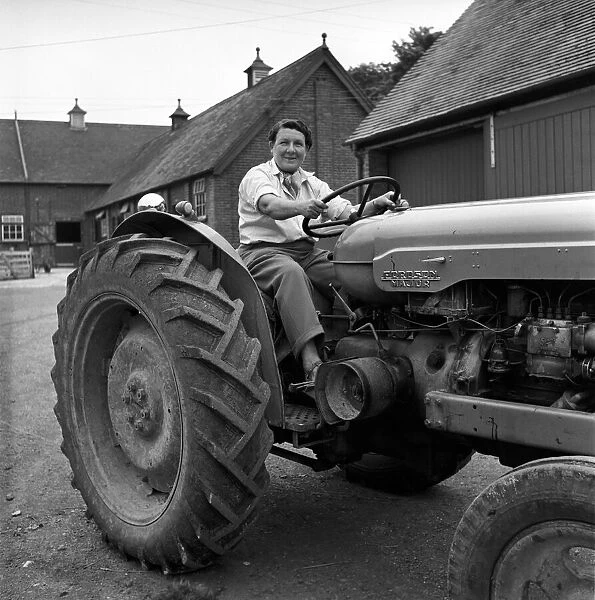 Mrs. Moss a livestock farmer seen here driving a Ferguson tractor around the farm. 1954
