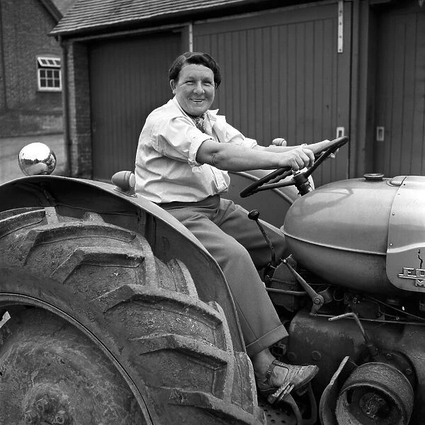 Mrs. Moss a livestock farmer seen here driving a Ferguson tractor around the farm. 1954