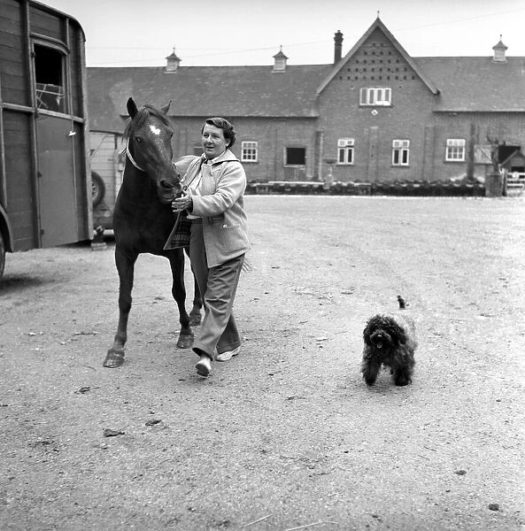Mrs. Moss a livestock farmer seen here with her horse and pet dog in the farm yard