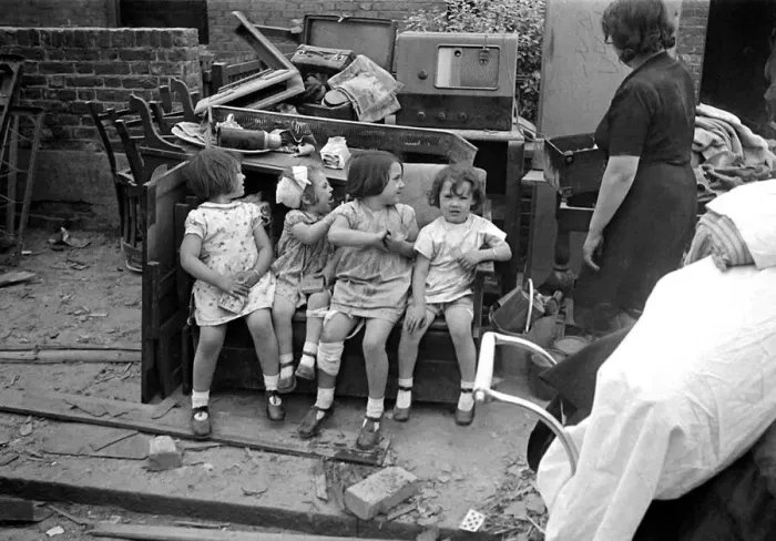 Framed Print : Mrs Rayner and children surrounded by bomb damage on St Marys Road