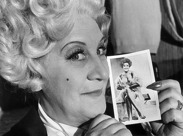 Mrs Slocombe (Actress Molly Sugden) seen here showing off her passport photograph for a