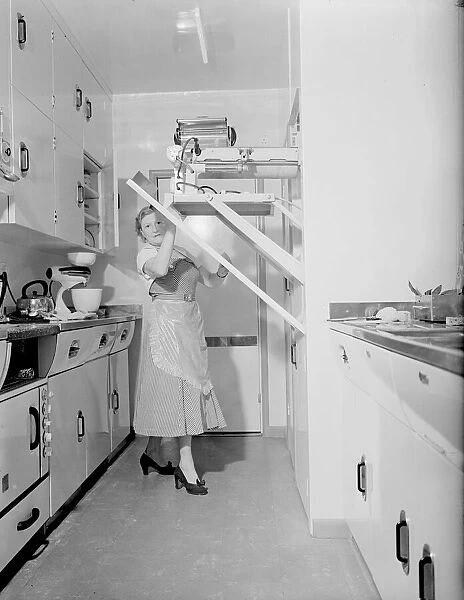 Mrs Susan Davies seen here putting away here rotary iron in a kitchen full of labour