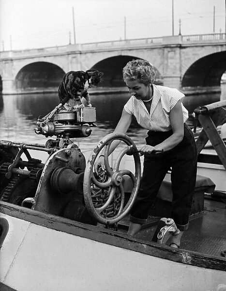 Mrs Tepper on her boat Cornelia with her cat Sinbad, at Kingston Bridge, London