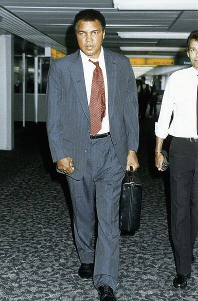 Muhammad Ali arriving at Heathrow airport after visiting war victims in Iran