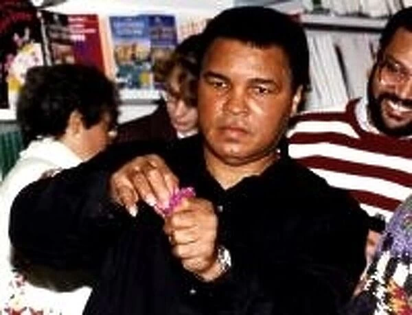 Muhammad Ali (Cassius Clay) former boxing champion does tricks to entertain the crowd