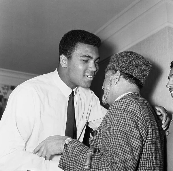 Muhammad Ali (Cassius Clay) greeting muslims at a public speaking about Islam