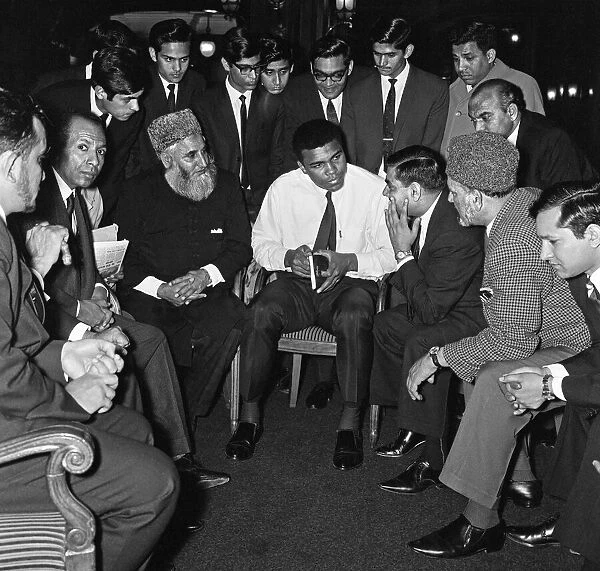 Muhammad Ali (Cassius Clay) speaking to Muslims holding a book called Towards
