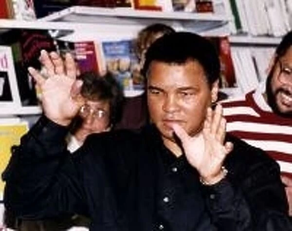 Muhammad Ali (Cassius Clay) former world heavyweight boxing champion with hands up at W