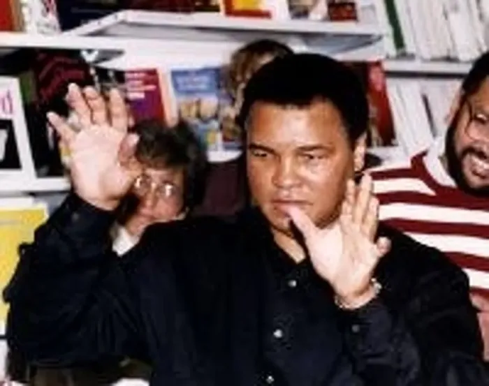 : Muhammad Ali (Cassius Clay) former world heavyweight boxing champion with hands up at W : Muhammad Ali (Cassius Clay) former world heavyweight boxing champion with hands up at W