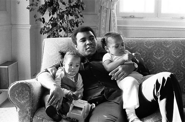 Muhammad Ali cuddling his daughters Laila, (left )and Hana (right