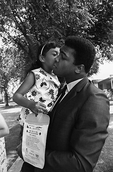 Muhammad Ali gets a kiss on the cheek from a young fan. 31st August 1967