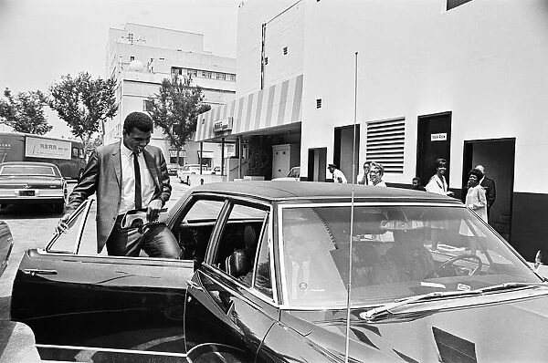 Muhammad Ali getting back into his car after meeting some of his fans
