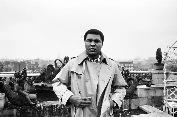 Muhammad Ali, former heavyweight boxing champion, stepping outside into the rain after a