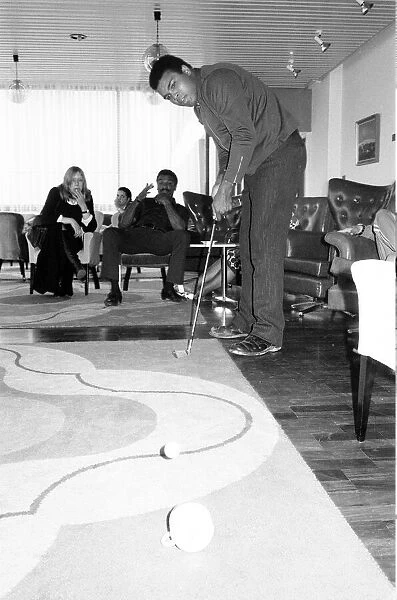 Muhammad Ali pictured having a round of tea-cup golf at his hotel near Dublin Ireland