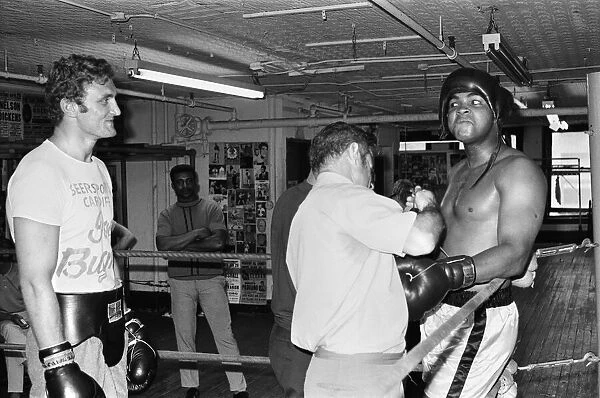 Muhammad Ali (right) getting ready to spar with a young Joe Bugner at a gym in New York