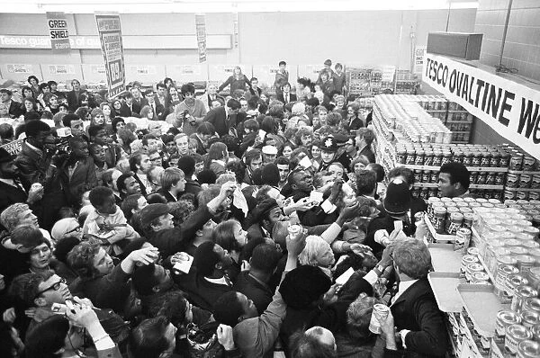 Muhammad Ali at a supermarket in Stretford to promote Ovaltine cornered by loads of fans