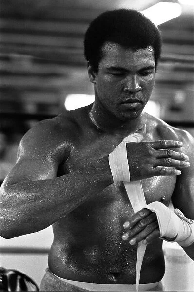 Muhammad Ali wrappings his hands in the gym at his training camp in Deer Lake