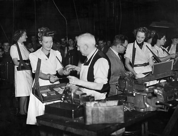 Munition girls selling war certificates to workers in their factory in the Midlands