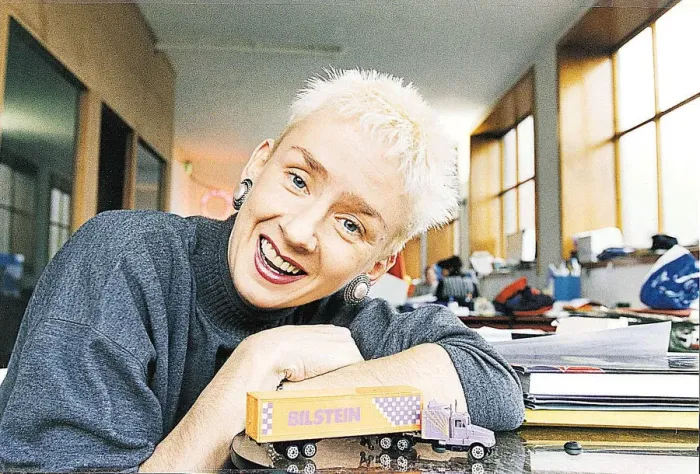 Framed Print : Muriel Gray leaning on desk with toy American truck TV Presenter A©mirrorpix