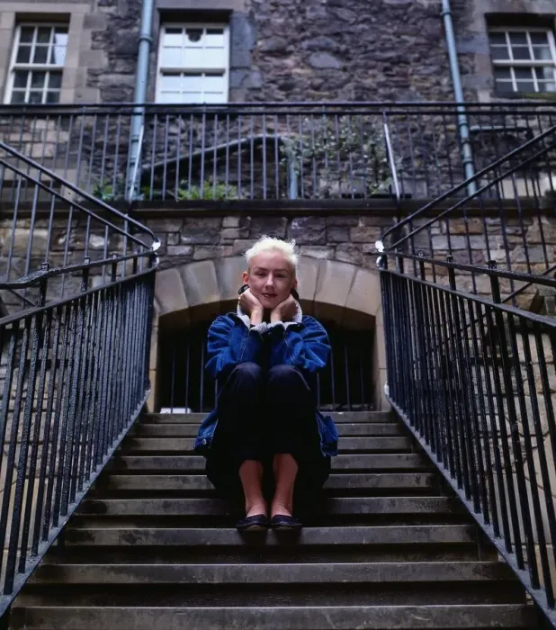 Framed Print : Muriel Gray TV presenter sitting on stairs steps Framed Print : Muriel Gray TV presenter sitting on stairs steps