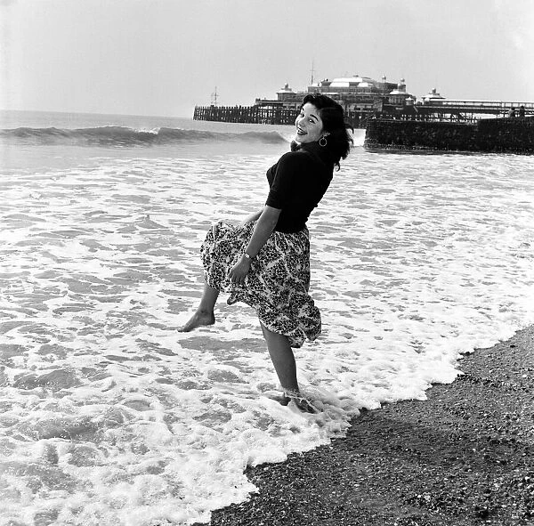 Muriel Harvey paddling in the sea at Brighton, East Sussex. 13th April 1954