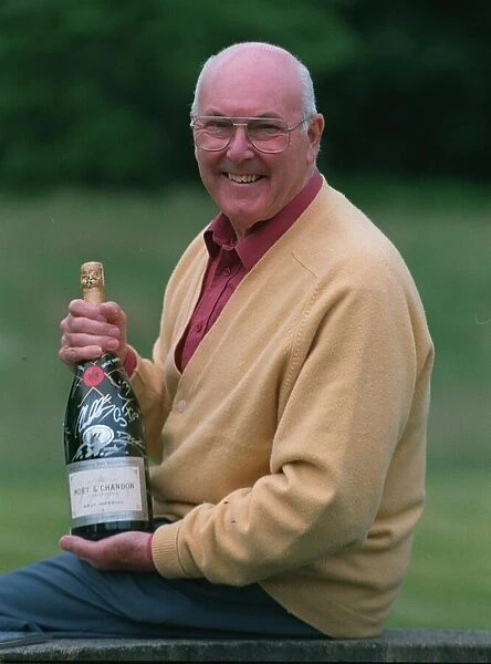 Murray Walker Motoracing Commentator July 1997 holding bottle of champagne