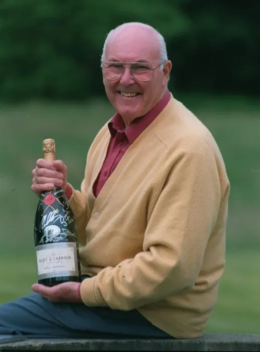 Framed Print : Murray Walker Motoracing Commentator July 1997 holding bottle of champagne