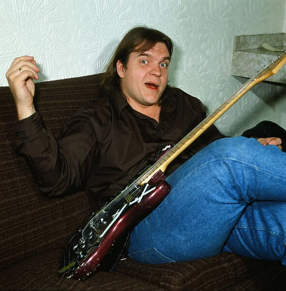 Musician Meat Loaf playing his guitar. September 1983