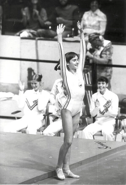 Nadia Comaneci of Romania salutes after a prefect gymnastic score of 10