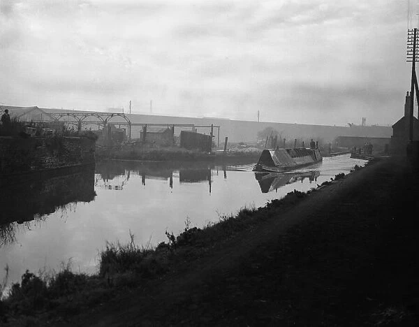 A narrow boat makes it way through the Manure lock basin at Wolverhampton 12th January