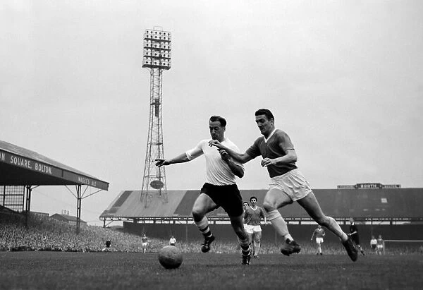 Nat lofthouse of Bolton Wanderers is challenged for the ball by Manchester United