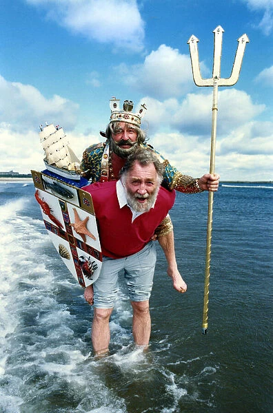 Naturalist David Bellamy carries Neptune, alias Mr Phil Lodge out of the surf on the Blue